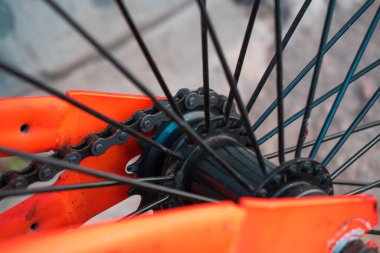  the bike in details is orange with black wheels worn not new