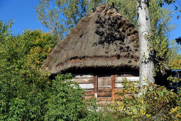 Lublin, Poland - September 30 2012: Wooden thatched barn on a sunny autumn day