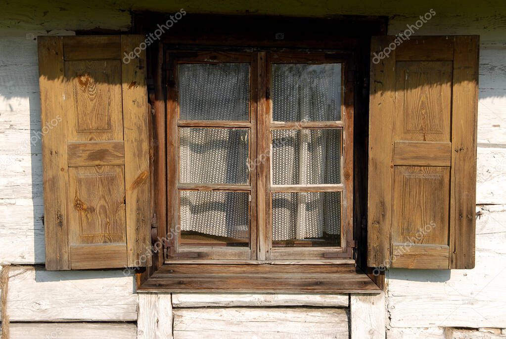 Wooden windows with open shutters, Poland