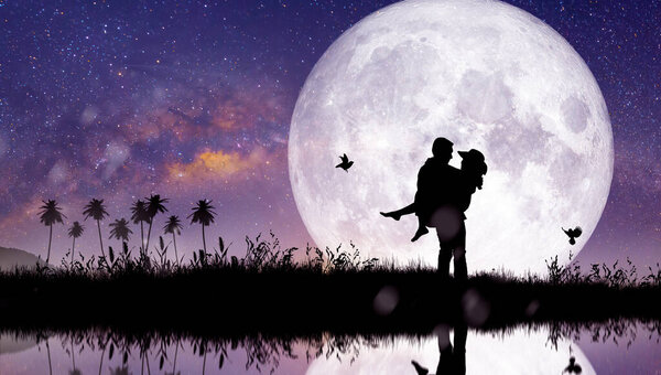 Silhouette at night landscape of couple or lover dancing and singing on the mountain with Milky way background over the full moon.