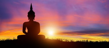 Silhouette of Buddha mediating in the twilight with sunrise background. Magha Puja, Asanha Puja, and Visakha Puja Day. Buddhist holiday Concept.
