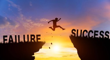 Silhouette man jumping from FAILURE to SUCCESS wording on cliffs with cloud sky and sunrise. Successful achievement Concept.