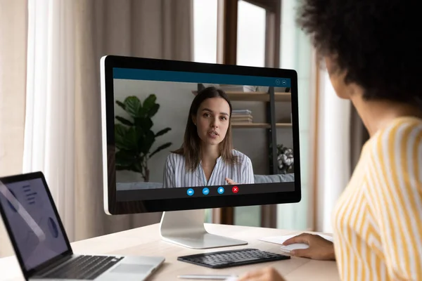 Concentrated young african ethnicity businesswoman holding video call conversation. — Stock Photo, Image