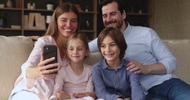 Genç anne, küçük kız, akıllı telefondan selfie çekiyor.