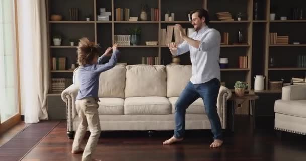 Funny family single father schoolboy son enjoy dancing at home — Stock Video