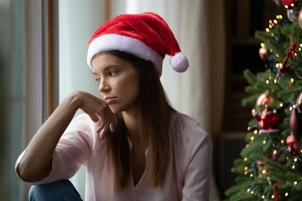 Depresja samotna dziewczyna w Red Xmas Santa kapelusz świętowanie Bożego Narodzenia — Zdjęcie stockowe