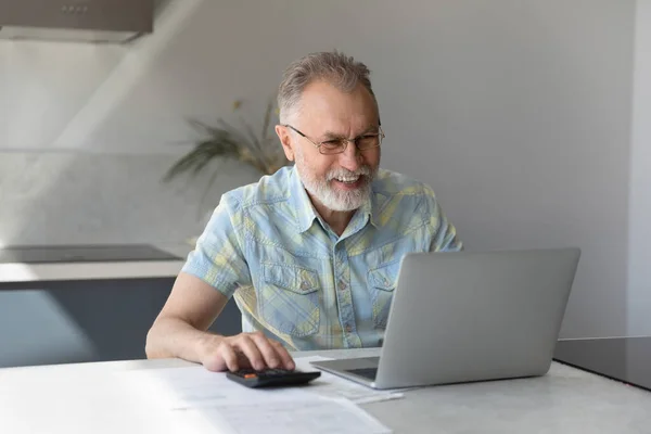 Happy old mature man calculating household budget. — Stock Photo, Image