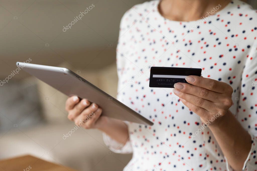 Shopper using tablet for buying on internet, paying for purchase