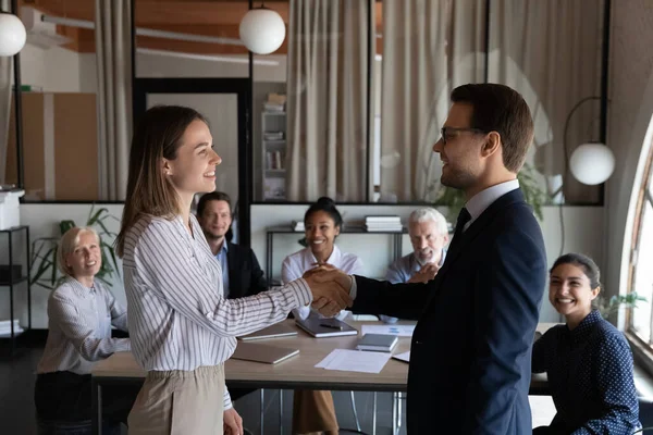 Grateful boss shake hand of female intern hiring on job