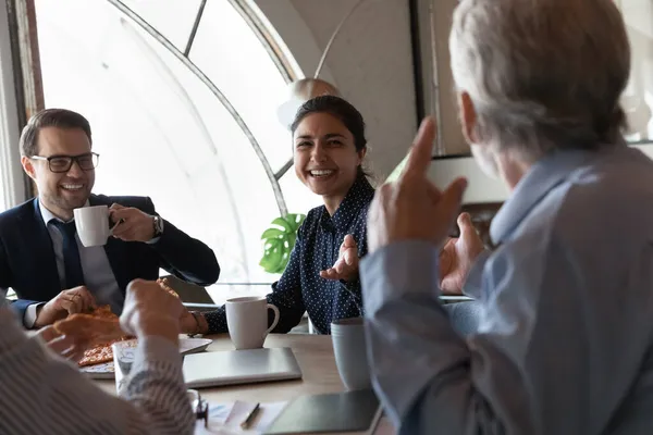 Happy friendly multiethnic staff group enjoy eating pizza in office — Stock Photo, Image