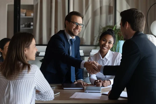 Friendly young man leader shake hand of new staff member — Stock Photo, Image