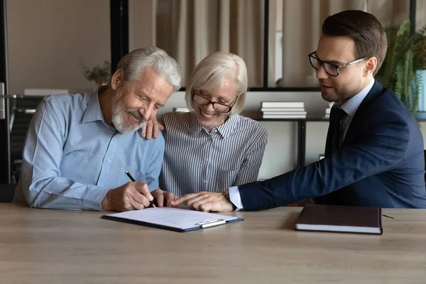 Satisfied husband wife retirees put signatures under life insurance policy