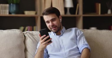 Portatif kulaklıklı genç adam görüntülü konuşma ile konuşuyor.