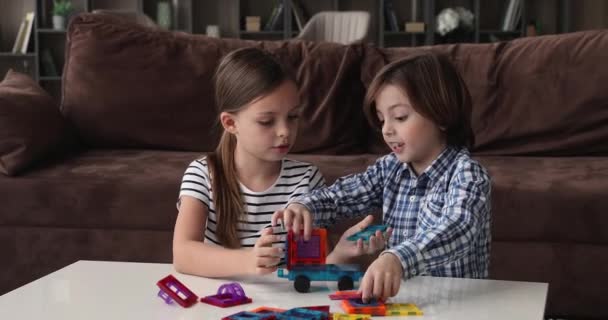 Happy adorable little children siblings playing toys at home. — Stock Video