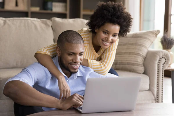 Happy young african american couple using computer.
