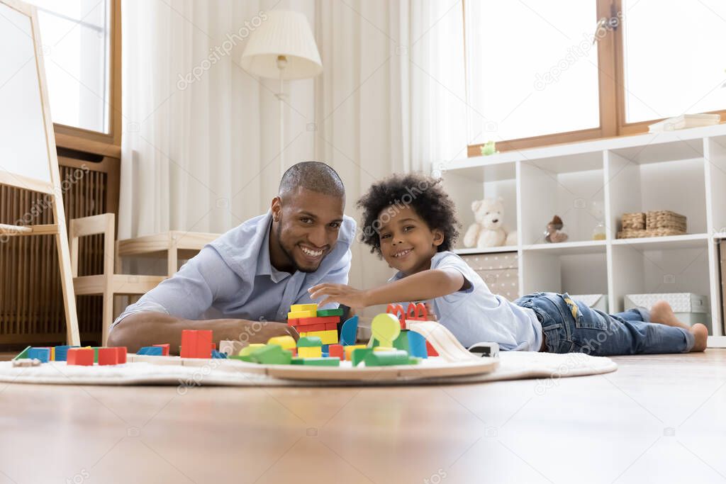Portrait of happy bonding african american family playing toys.