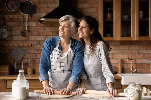 Feliz maduro 60s madre y adulto hija mujer hornear pastel —  Fotos de Stock