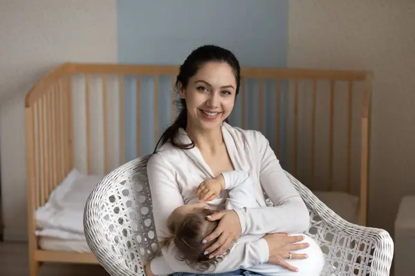 Head shot portrait smiling loving mother breastfeeding little daughter — Stock Photo, Image