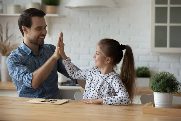 Joyful millennial father giving high five to small daughter. — Stock Photo, Image