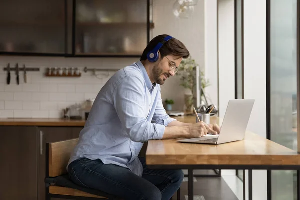 Happy interested millennial man studying on online courses. — Stock Photo, Image