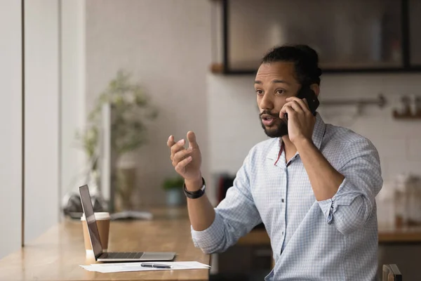 Professional young african american businessman multitasking in modern office. — Stock Photo, Image