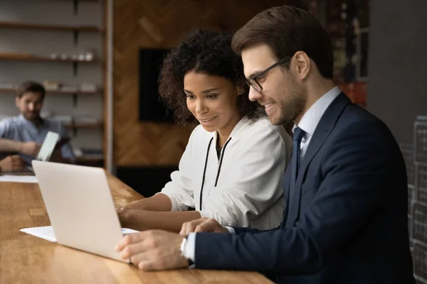 Happy young mixed race business people working on computer. — Stock Photo, Image