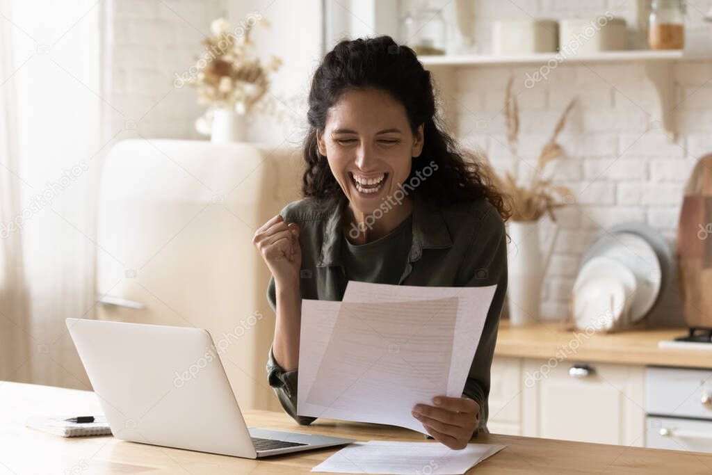 Young woman reading bank notice with good news feels excited