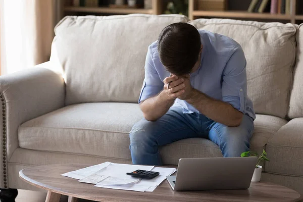 Unhappy young man having financial problems, calculating budget. — Stock Photo, Image