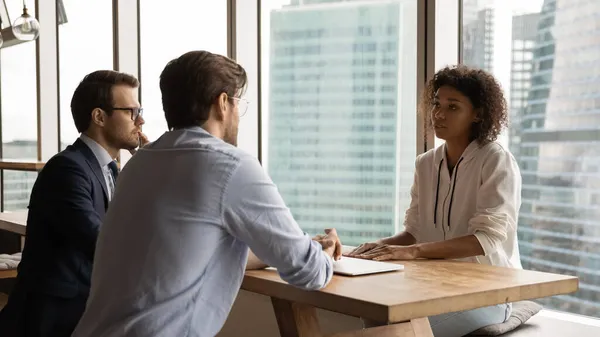 Focused male employers interviewing african american candidate. — Stock Photo, Image