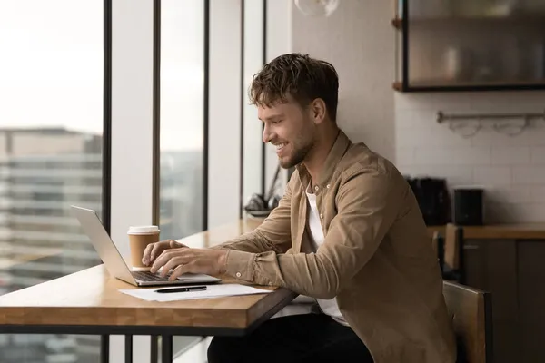 Gelukkig jong Kaukasisch man werken op computer. — Stockfoto