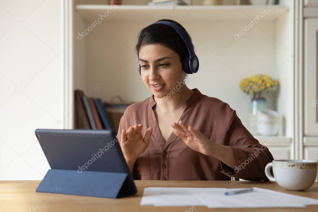 Student woman engaged in e-learning through videocall app on tablet