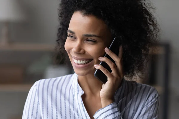 Head shot smiling African American woman talking on phone