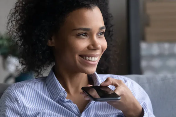Close up smiling African American woman recording audio message — Stock Photo, Image