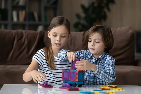 Little boy and girl playing with colorful plastic blocks — Stock Photo, Image