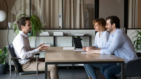 Young couple of hr managers holding job interview with candidate. — Stock Photo, Image