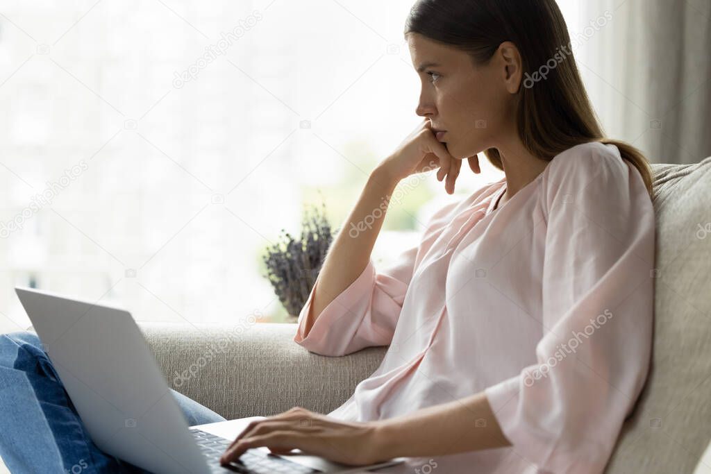Pensive young woman thinking on problem solution, working on computer.