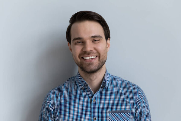 Portrait of happy young man posing on white studio background.