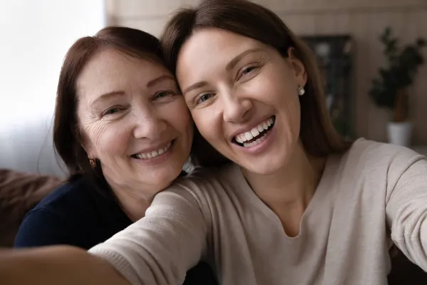 Head shot portrait happy woman with mature mother taking selfie — Stock Photo, Image