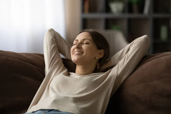 Woman lean on sofa closing eyes breath fresh conditioned air — Stock Photo, Image