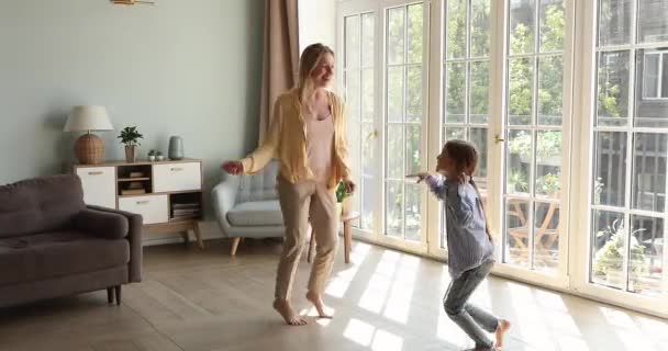 Two sisters grownup older younger schoolgirl dancing at living room — Stock Video