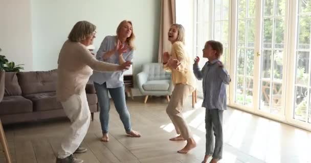 Bisabuela envejecida abuelita joven mamá pequeña hija bailar juntos — Vídeos de Stock