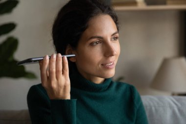 Genç bayan hoparlör modunda telefon kullanıyor. Sesli mesaj dinleyin.