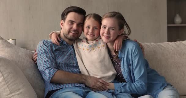 Портрет мати батько маленька дівчинка обіймається на дивані грати лоскотати — стокове відео