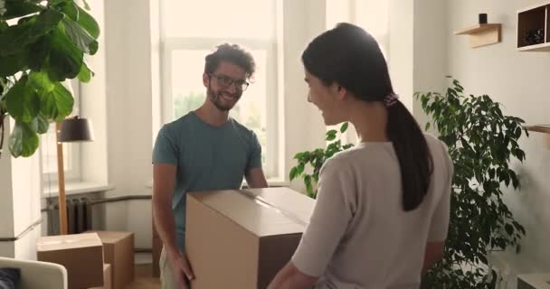 Jong stel verhuizen naar nieuwe huis dragen pakketten met spullen — Stockvideo