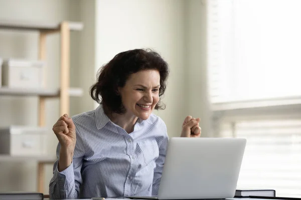 Happy excited middle aged female business leader celebrating achieve — Stock Photo, Image