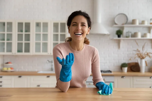 Head shot portrait excited woman in gloves cleaning wooden table — Stock Photo, Image