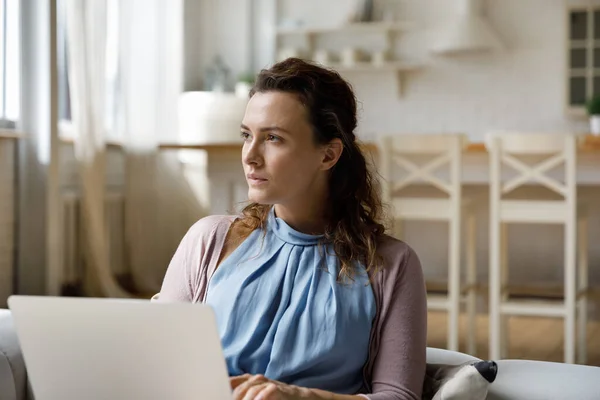 Serious millennial freelance mujer que trabaja en línea en el ordenador portátil desde casa —  Fotos de Stock