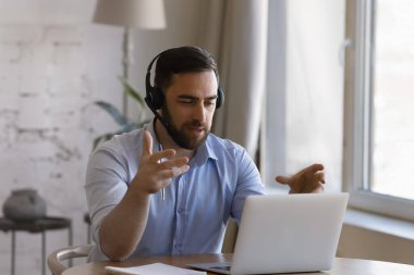 Mutlu akıllı genç iş adamı video aracılığıyla iletişim kuruyor..