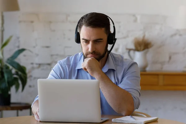 Concentrated young man holding video call meeting. — Stock Photo, Image