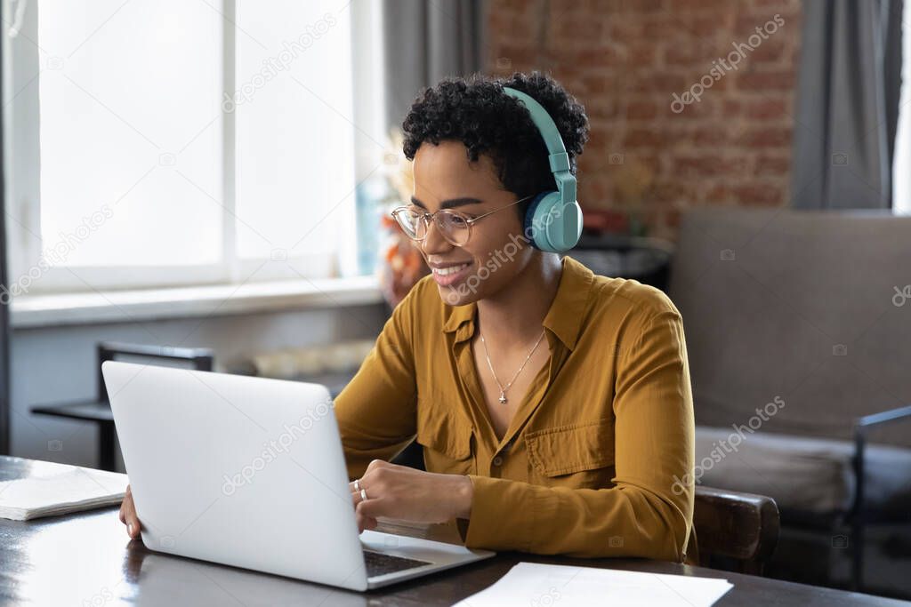 Happy beautiful young African American woman holding video call.